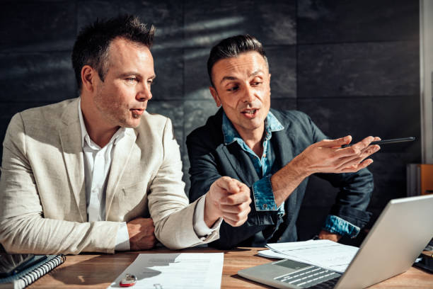 istock Two businessman discussing over the laptop 1144313141