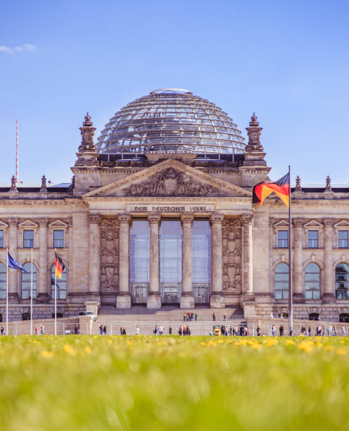 German parliament, Berliner Reichstag in springtime: Tourist attraction in Berlin Picture of the Reichstag in Berlin in Springtime, green grass and flowers populism stock pictures, royalty-free photos & images