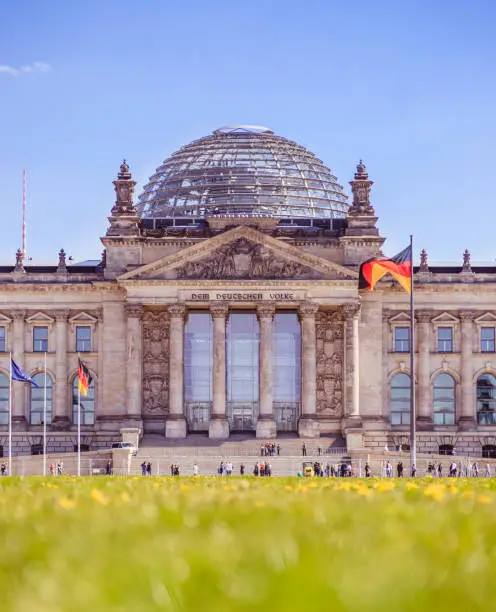 Picture of the Reichstag in Berlin in Springtime, green grass and flowers