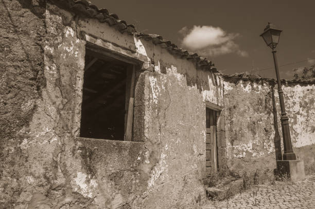 istock Old houses with worn plaster on deserted alley 1144317867