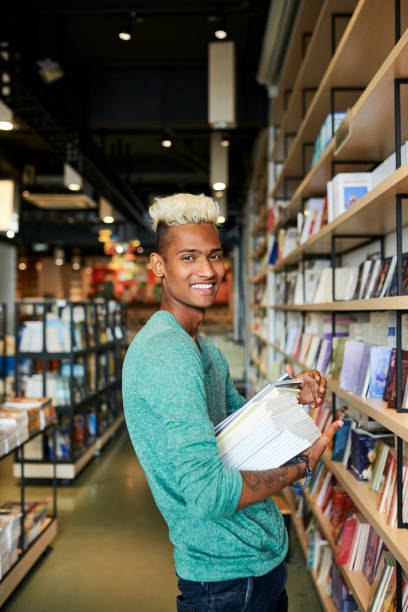 istock Happy bookstore employee in shop 1144319295