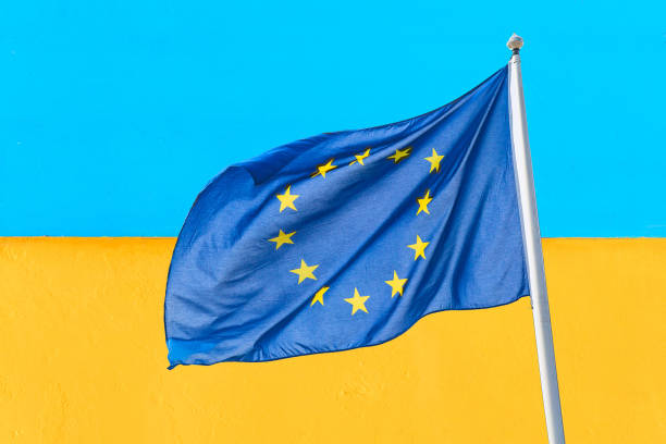 die ukraine und die europäische union. waving european union flag against blue yellow wall ukrainiinian flag. die ukraine geht nach europa-konzept. - passport sweden customs europe stock-fotos und bilder