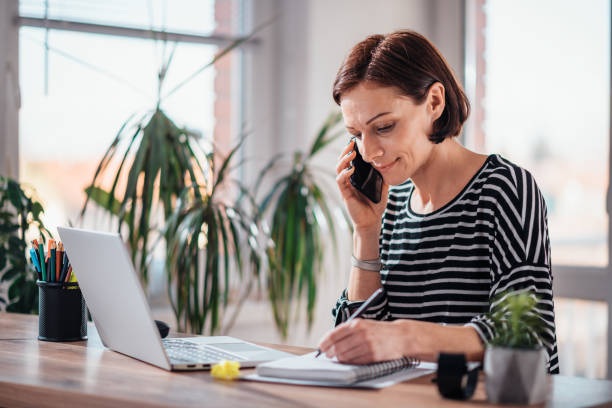 istock Woman talking on the smart phone in the office 1144320086