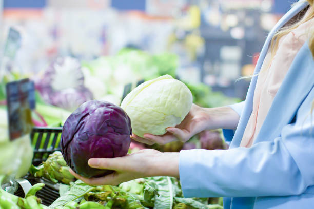 istock Women hand choosing a cabbage at supermarket 1144320087
