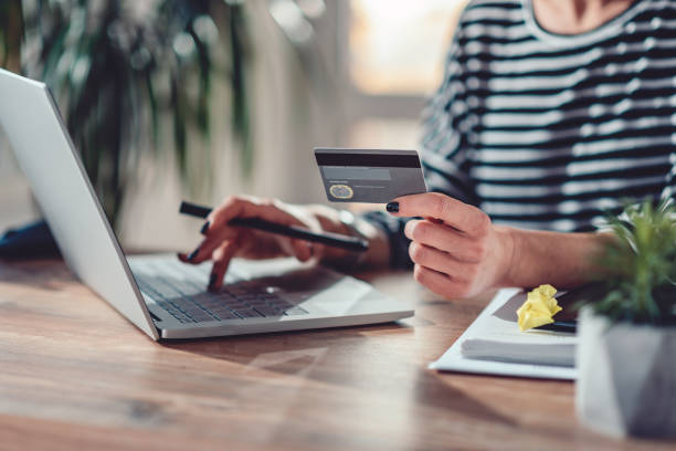 istock Woman shopping online and using credit card 1144320194