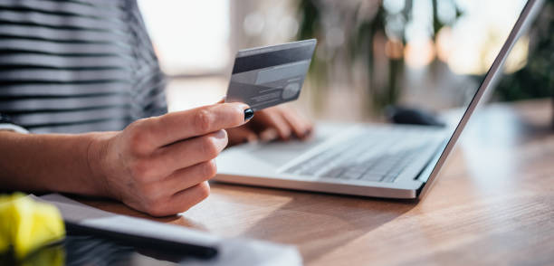 istock Woman shopping online and using credit card 1144320365
