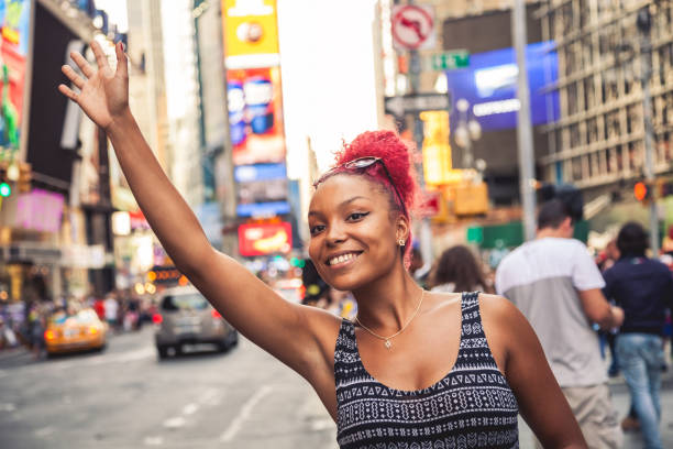 istock Millennial hailing a ride in Times Square - New York 1144320385