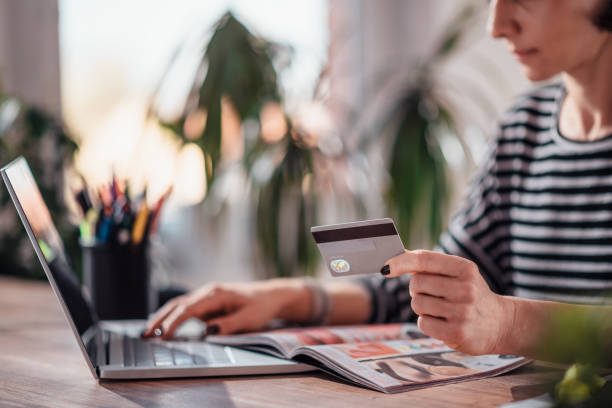 Woman shopping online and using credit card