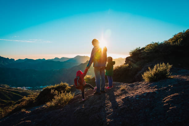 istock Father with kids travel in sunset mountains 1144321987