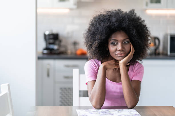 istock Thoughtfully african woman sitting home alone 1144322130