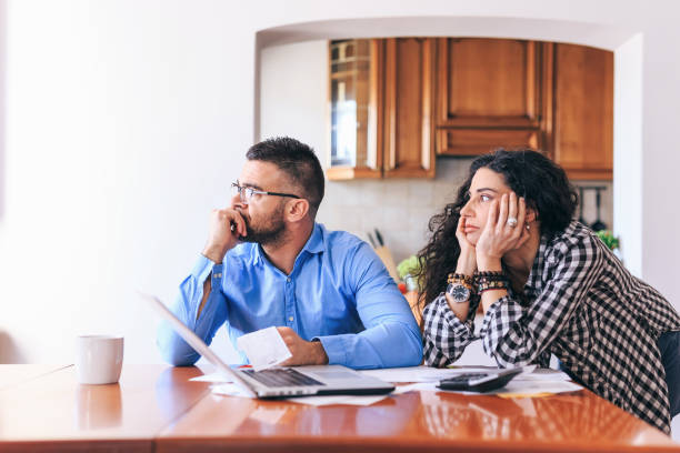 istock Couple making home bills and using laptop 1144322506