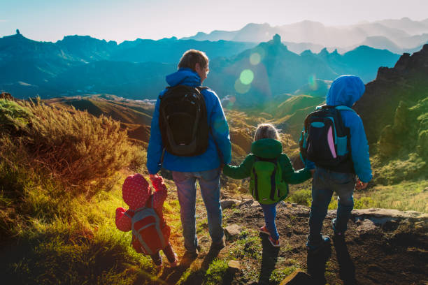 istock Father with kids travel in sunset mountains 1144322537