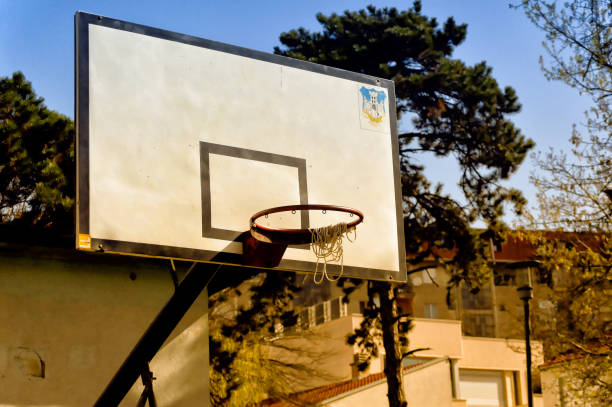 istock Basketball construction with broken net wrapped around hoop. 1144324479