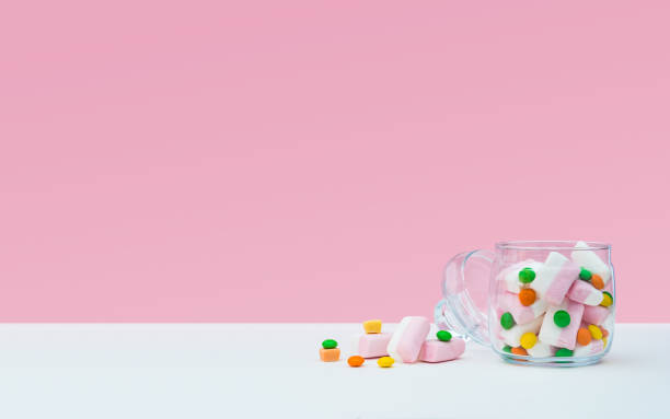 istock Marshmallow with dragee next to the glass open transparent jar and in it 1144324566