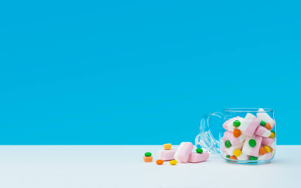 istock Marshmallow with dragee next to the glass open transparent jar and in it 1144324568