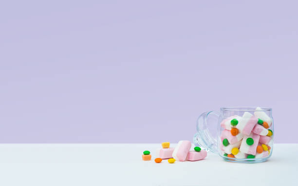 istock Marshmallow with dragee next to the glass open transparent jar and in it 1144324569