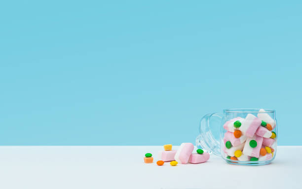istock Marshmallow with dragee next to the glass open transparent jar and in it 1144324589