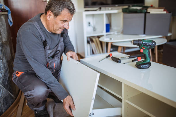 istock The man is assembling furniture from chipboard boards 1144329337