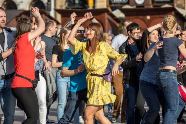 Cracow, Poland - Maerch 30, 2019:  International Flashmob Day of Rueda de Casino. Several hundred persons dance Hispanic rhythms on the Main Square in Cracow. Poland