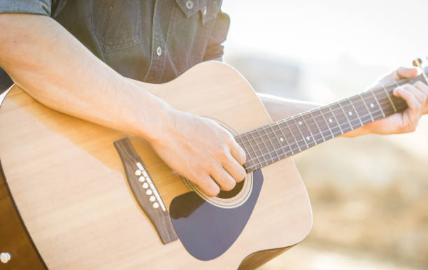 istock Playing on acoustic guitar outdoor 1144330768