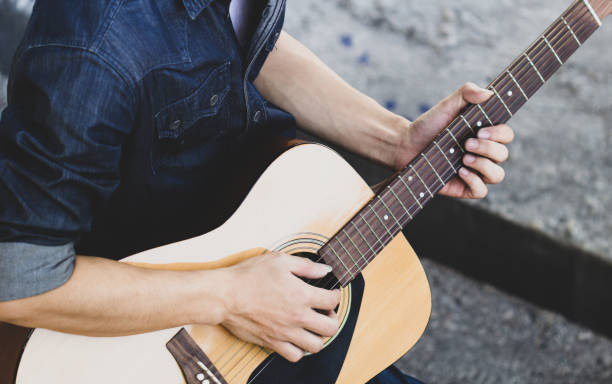 istock Playing on acoustic guitar outdoor 1144330806