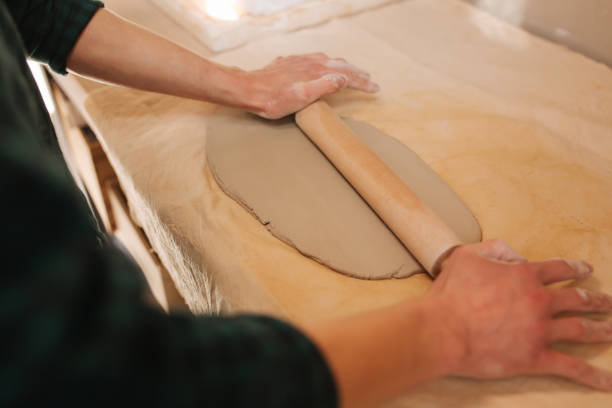 istock Male potter use rollong pin for clay. Man in workshop 1144331981