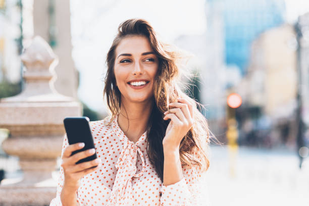 istock Happy woman using smart phone 1144332372