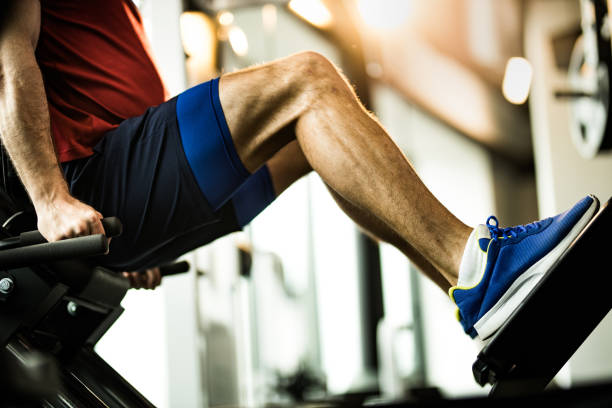 istock Unrecognizable athletic man exercising on leg press in a gym. 1144333310