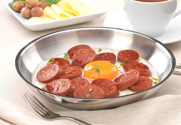 Copper pan with fried egg and sausage slices. One egg and meat pieces frying.Turkish breakfast. turkish sausage stock pictures, royalty-free photos & images