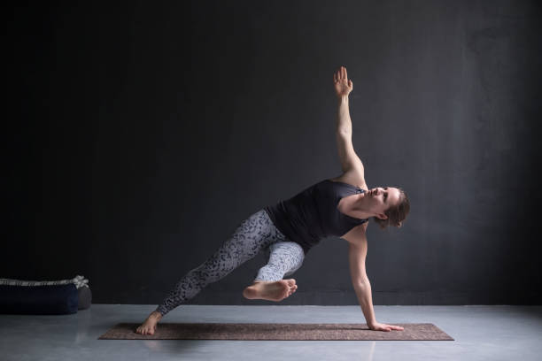 istock Young woman working out. Yoga pose Vasisthasana. 1144336426