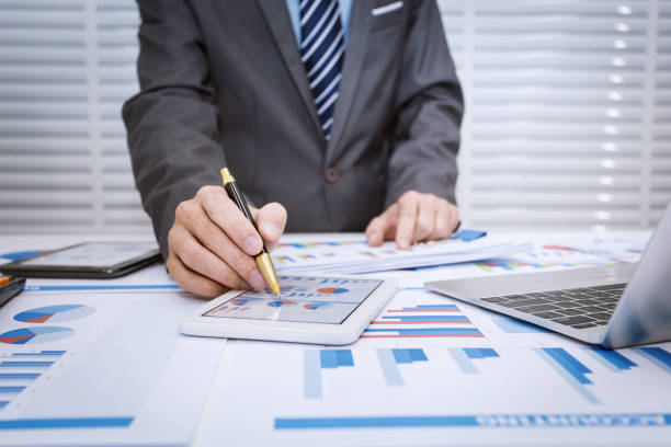 istock Business man looking at business document in touchpad 1144336794