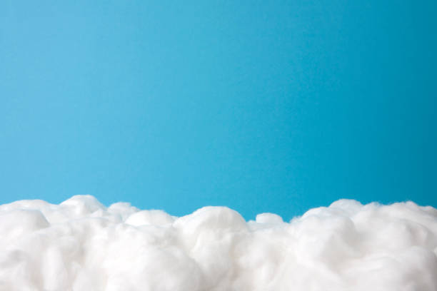 cloud made out of cotton wool on sky blue background cloud made out of cotton wool on sky blue background. cotton cloud stock pictures, royalty-free photos & images