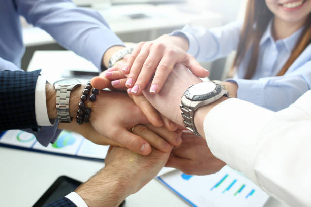 istock Group of people in suits crossed hands 1144337552