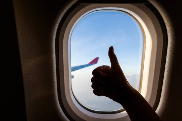istock Plane wing view from inside plane in midair with blue sky cloud background 1144338739