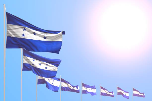 istock cute anthem day flag 3d illustration
 - many Honduras flags placed diagonal on blue sky with place for text 1144339111