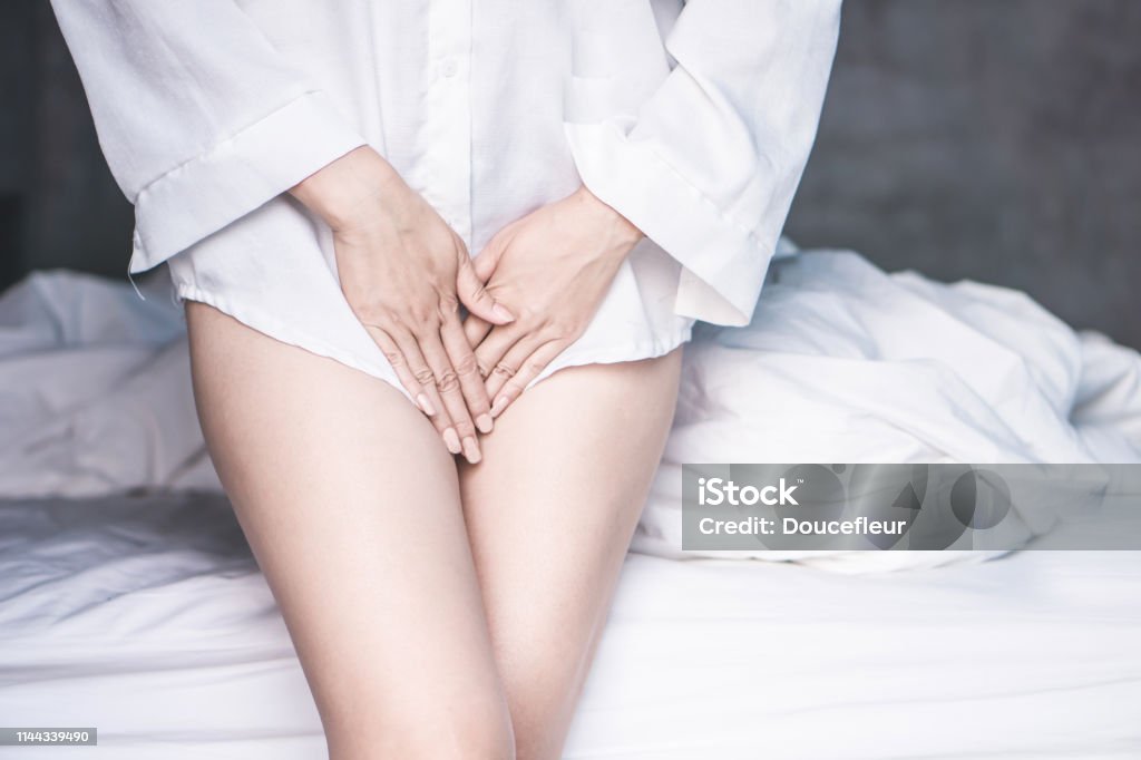 woman hand holding her crotch suffering from pain,itchy concept woman hand holding her crotch suffering from pain,itchy concept background Vagina Stock Photo