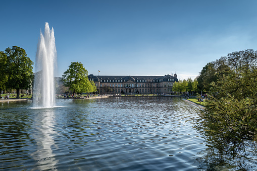 Lake with fountain and new castle in the Background at springtime.