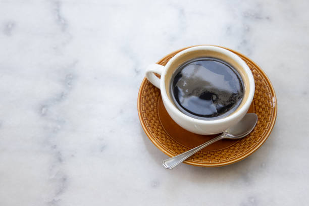 istock americano coffee. a cup of coffee on white marble table. 1144340712