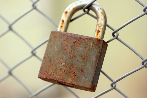 istock metal fence and rusty padlock 1144340770