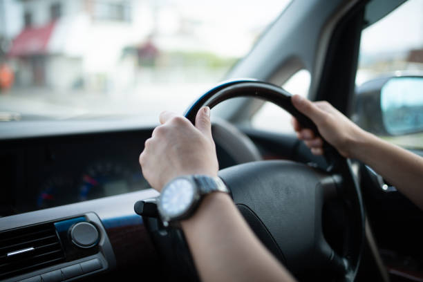Male hand driving a car