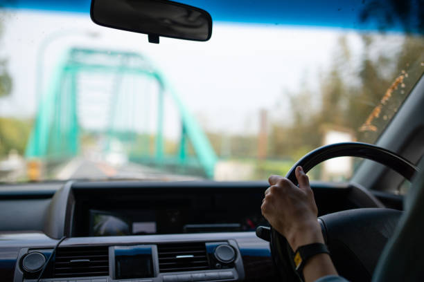 istock Female hand driving a car 1144342742