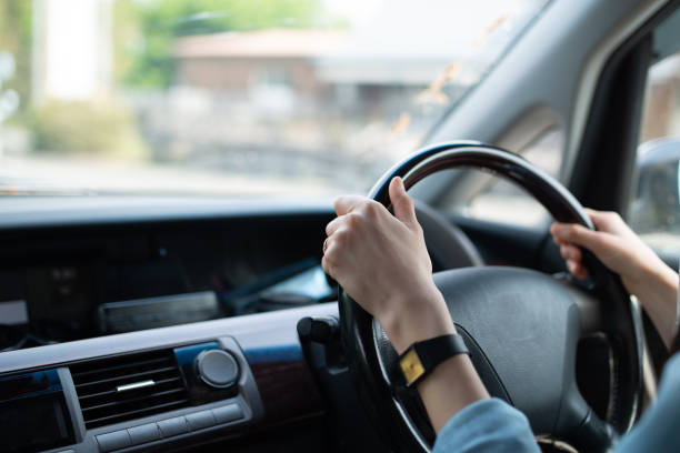 istock Female hand driving a car 1144343201