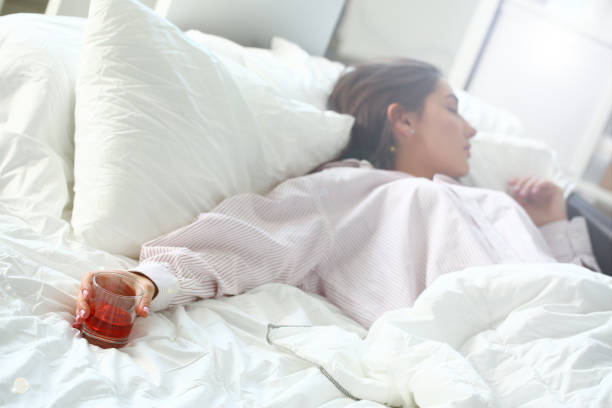 istock Young woman lying in bed deadly drunken 1144346249