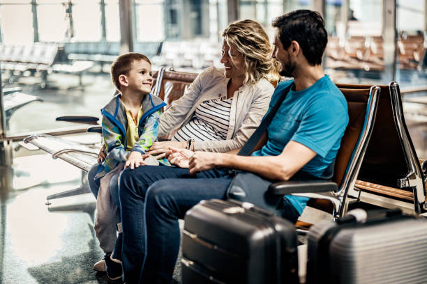 istock Happy family talking while waiting their transportation on a station. 1144347199