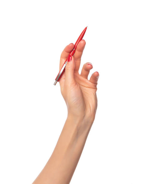 istock Female hand holding a pen on white background. 1144347291