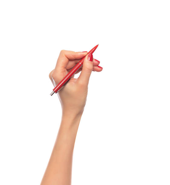 istock Female hand holding a pen on white background. 1144347308