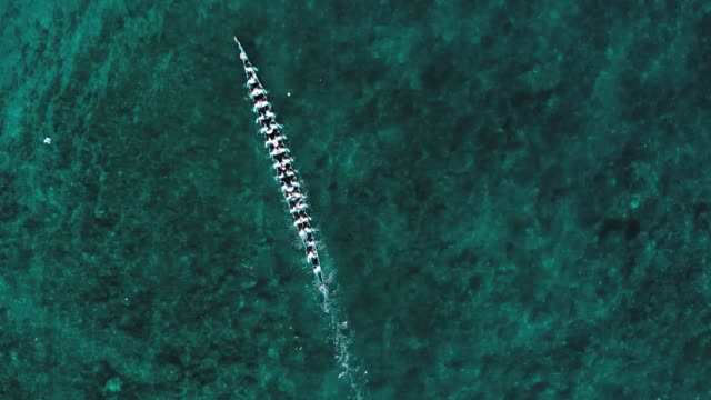 Aerial slow motion: top down kora-kora traditional canoe annual race in Bandaneira, Maluku, Indonesia