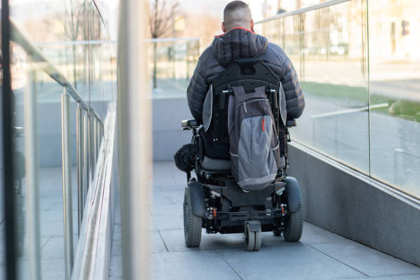 istock Man in a electric wheelchair using a ramp 1144347899
