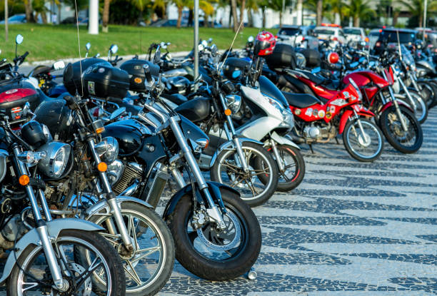 a series of motorbikes parked in a lot