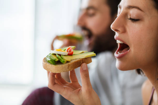 istock Woman eating healthy sandwich 1144348098